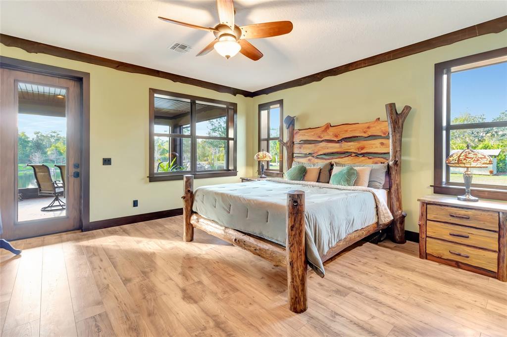 7330 Crabgrass Road St. Cloud, FL 34773 - Photo 4 of 60 a bedroom with a bed and a chandelier