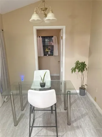 a view of a livingroom with furniture and a potted plant