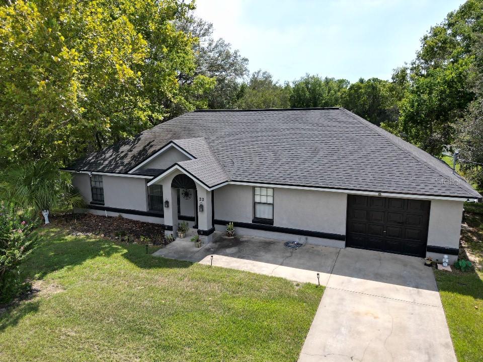 20 Cedar Road Ocala, FL 34472 - Photo 2 of 28 a front view of house with yard and trees in the background