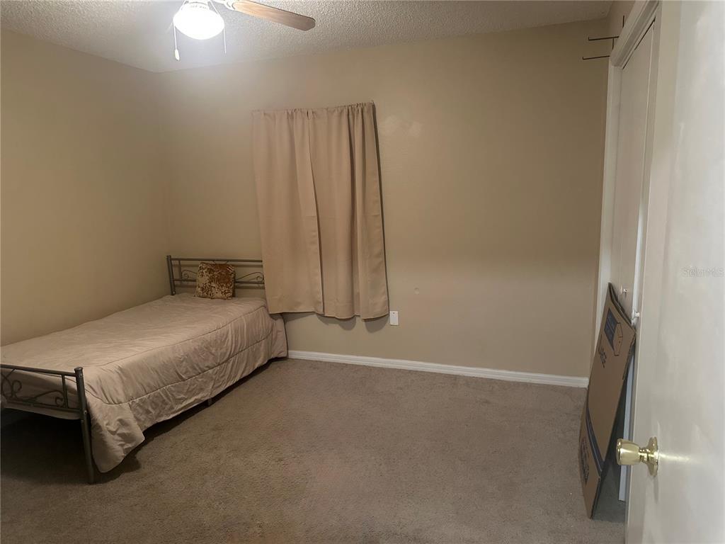 20 Cedar Road Ocala, FL 34472 - Photo 23 of 28 a bedroom with a bed and a window