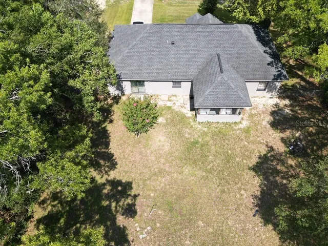 a aerial view of a house with a yard and garage