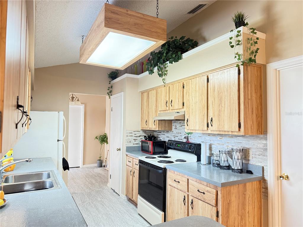 20 Cedar Road Ocala, FL 34472 - Photo 7 of 28 a kitchen with stainless steel appliances granite countertop a sink a stove and a refrigerator