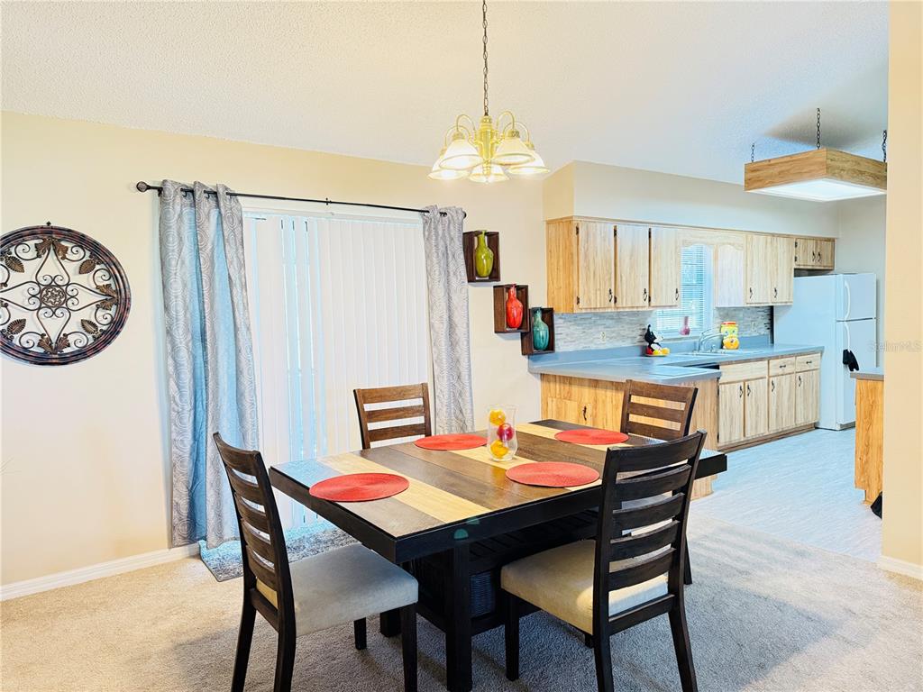 20 Cedar Road Ocala, FL 34472 - Photo 9 of 28 a dining room with furniture and a chandelier