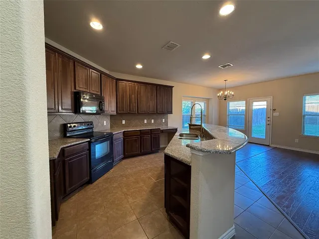 an empty room with a window and a fireplace