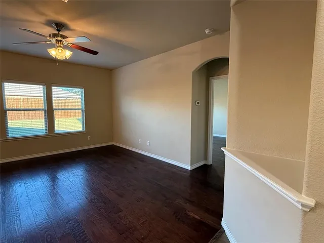 a kitchen with kitchen island granite countertop wooden cabinets a sink and a stove