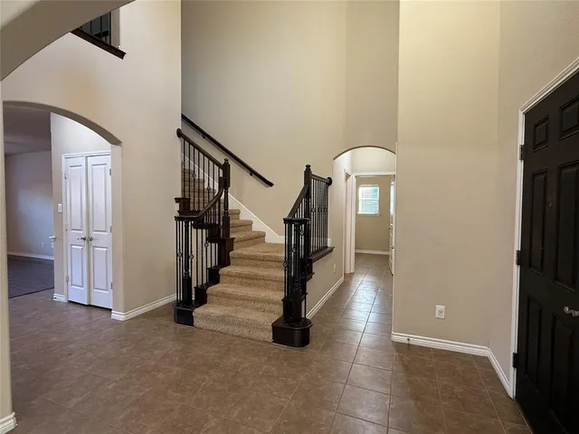 a kitchen with stainless steel appliances granite countertop a stove top oven a sink and a refrigerator