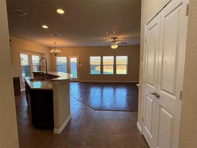 a bathroom with a tub a sink and a large mirror