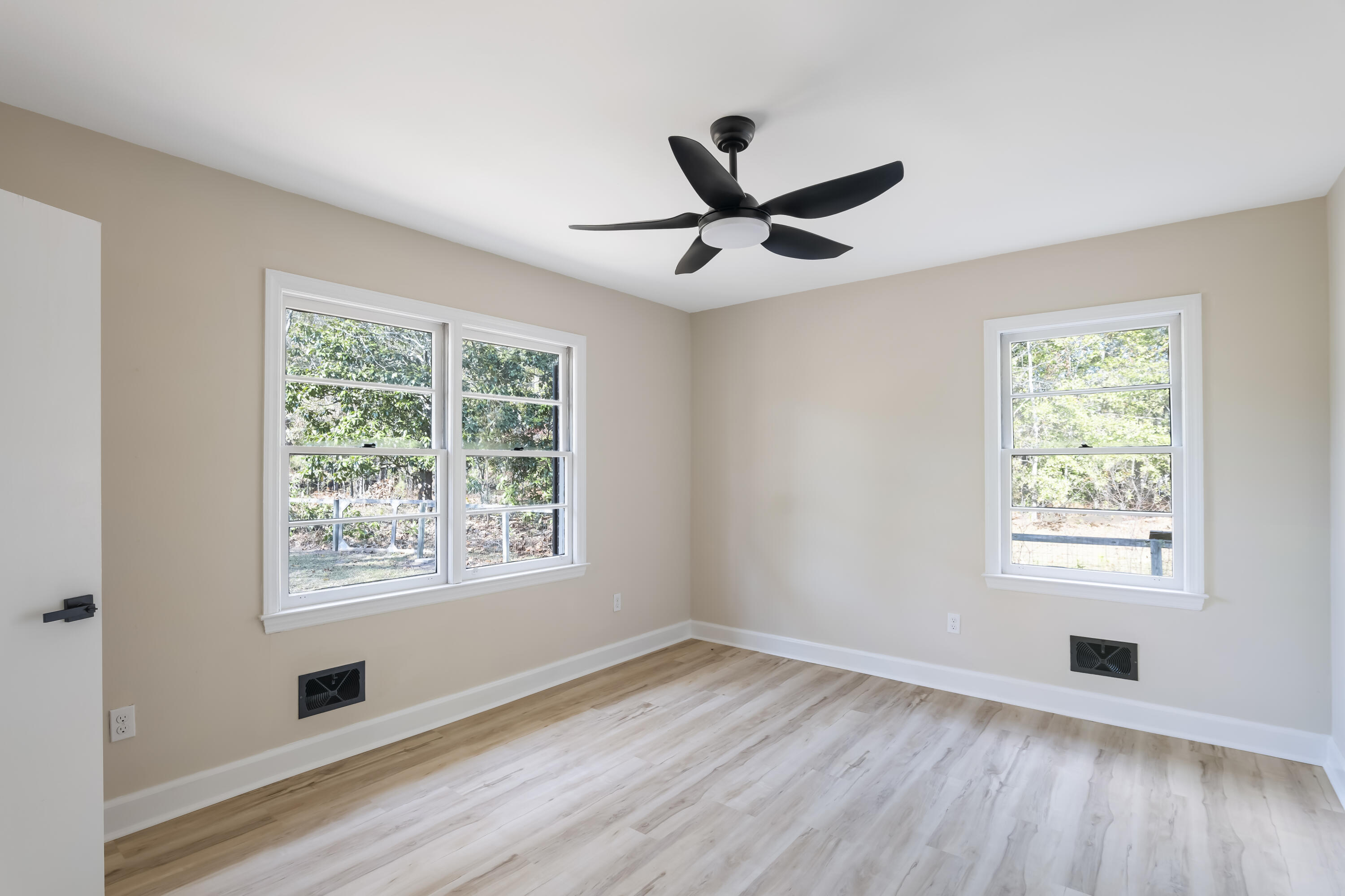 39 Gantt Street Wagener, SC 29164 - Photo 14 of 30 a view of an empty room with wooden floor and a window