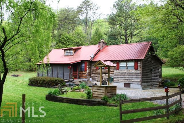 60 Hummingbird Lane Rabun Gap, GA 30568 - Photo 1 of 1 a front view of a house with a garden