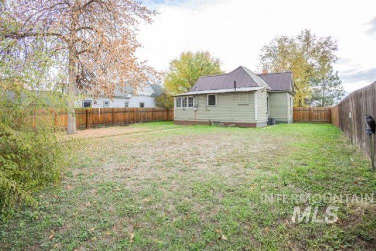 622 West Commercial Street Weiser, ID 83672 - Photo 21 of 21 Rear view of house with a metal roof and a fenced backyard