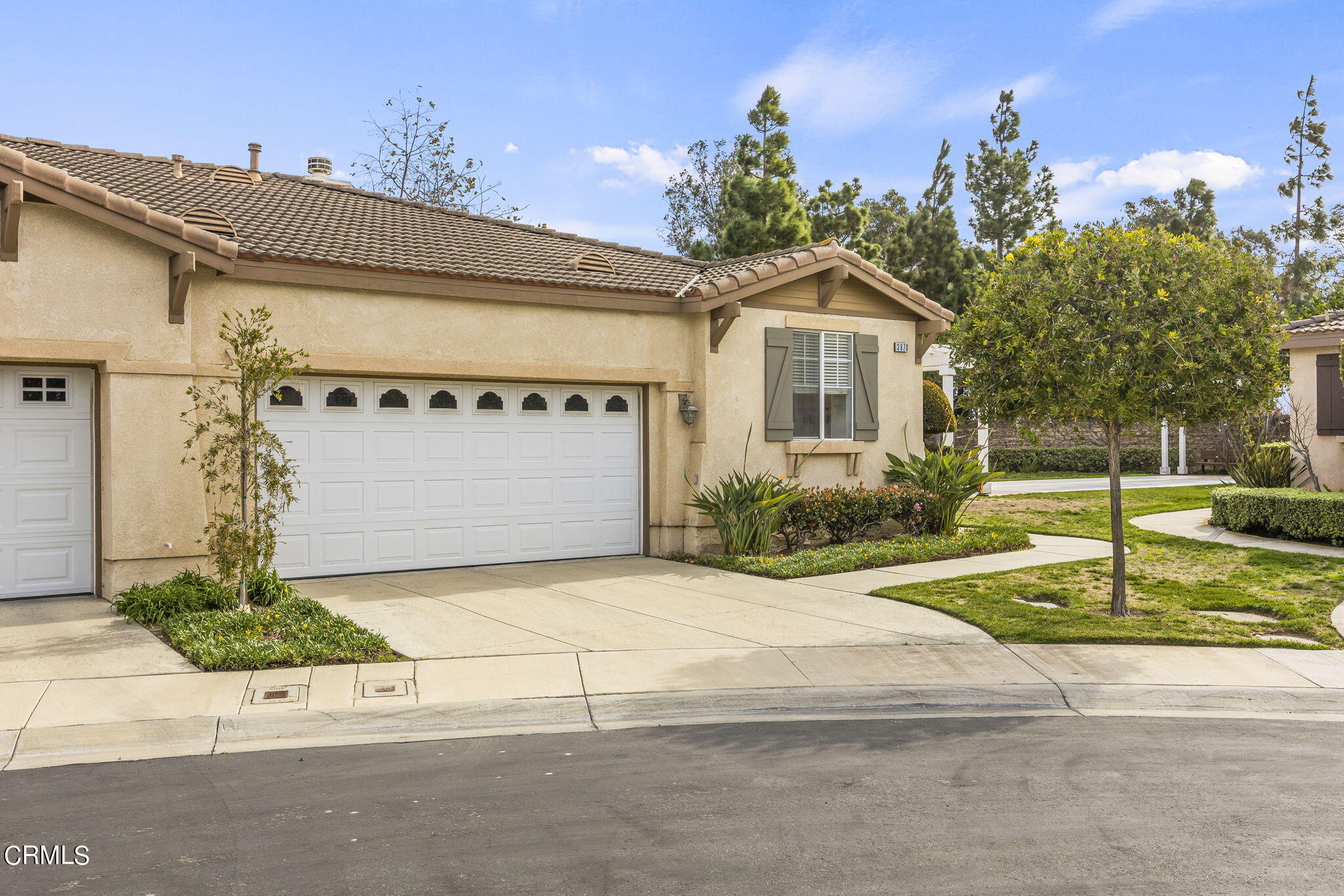 3870 Shakespeare Drive Oxnard, CA 93033 - Photo 2 of 29 a front view of a house with a yard and garage