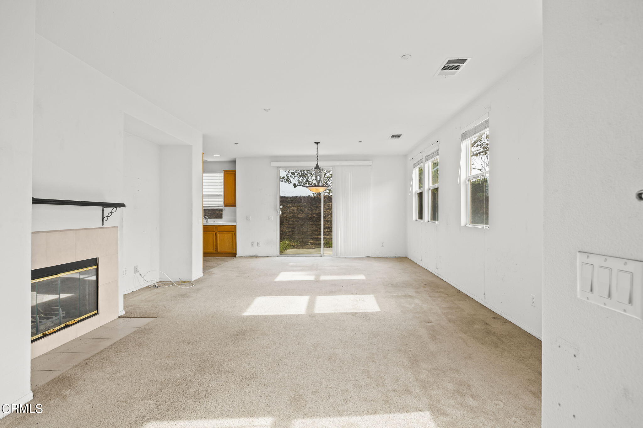 3870 Shakespeare Drive Oxnard, CA 93033 - Photo 5 of 29 a view of an empty room with a fireplace and a window