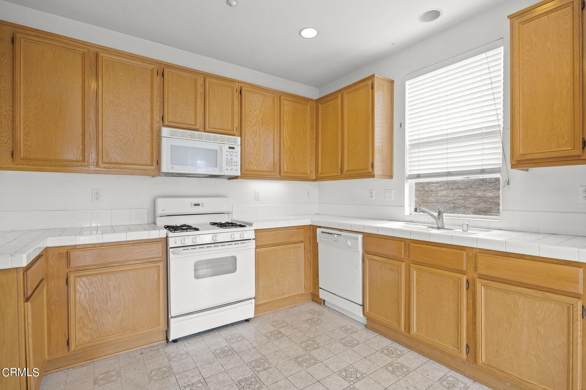 3870 Shakespeare Drive Oxnard, CA 93033 - Photo 9 of 29 a kitchen with sink cabinets and window