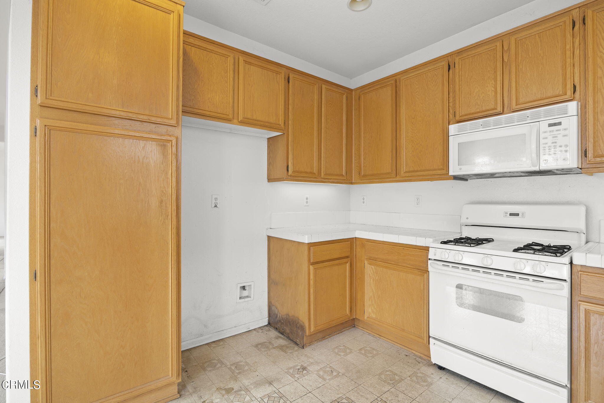 3870 Shakespeare Drive Oxnard, CA 93033 - Photo 10 of 29 a kitchen with a stove top oven a sink and cabinets