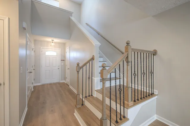 a view of staircase with railing and white walls