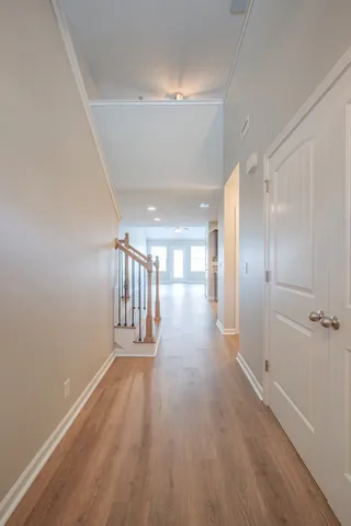 a view of a hallway with wooden floor