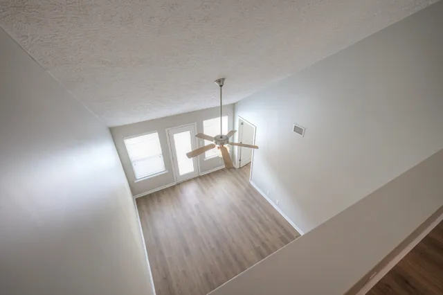a view of staircase with white walls and a window