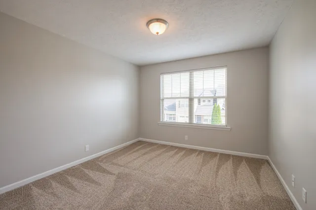 a view of an empty room and closet area