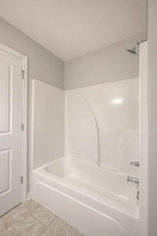 an empty room with a window and a ceiling fan