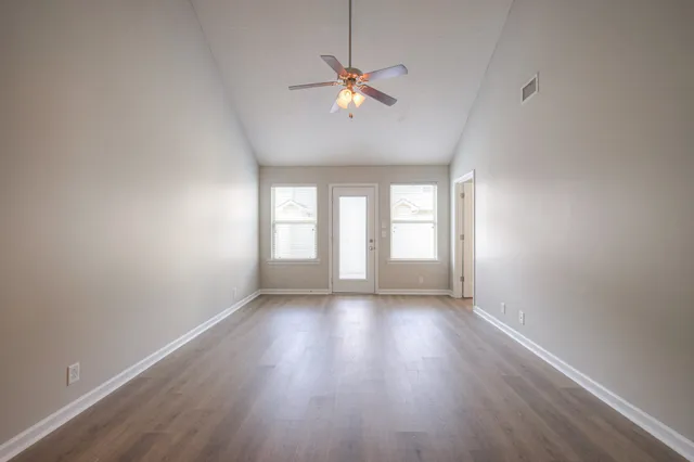 wooden floor in an empty room with a window