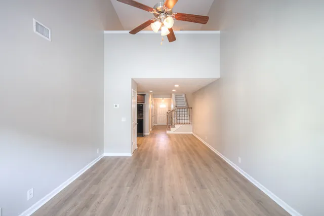 a view of a hallway with wooden floor