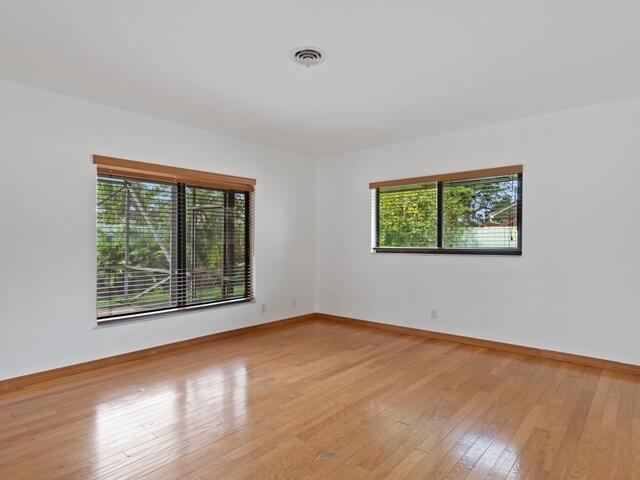 1705 Ashby Road Juno Beach, FL 33408 - Photo 11 of 21 a view of an empty room with wooden floor and a window