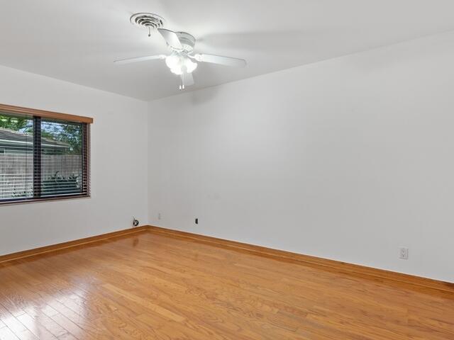 1705 Ashby Road Juno Beach, FL 33408 - Photo 14 of 21 wooden floor in an empty room with a window