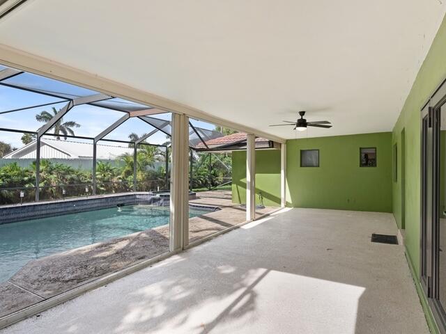 1705 Ashby Road Juno Beach, FL 33408 - Photo 2 of 21 a backyard of a house with table and chairs