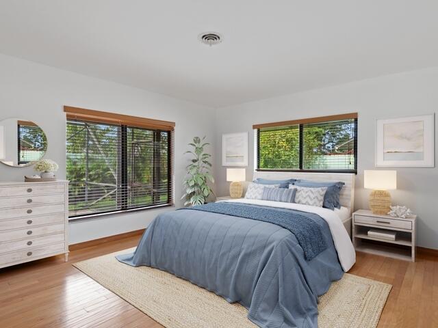 1705 Ashby Road Juno Beach, FL 33408 - Photo 10 of 21 a bedroom with a large bed and a large window