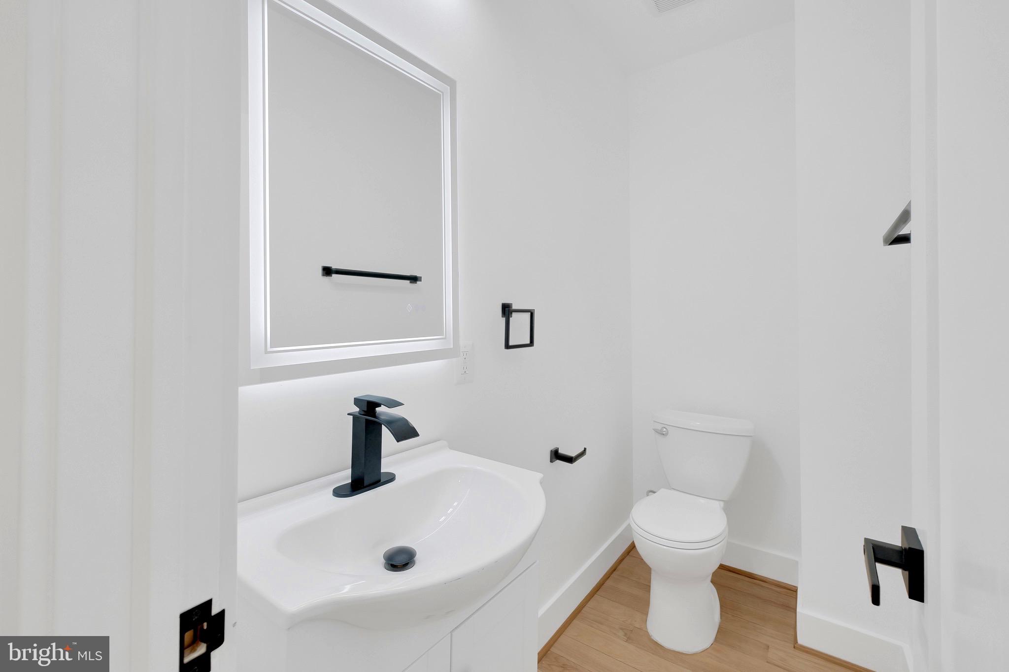 5318 5th Street Northwest Washington, DC 20011 - Photo 12 of 40 a bathroom with a sink a toilet and a mirror