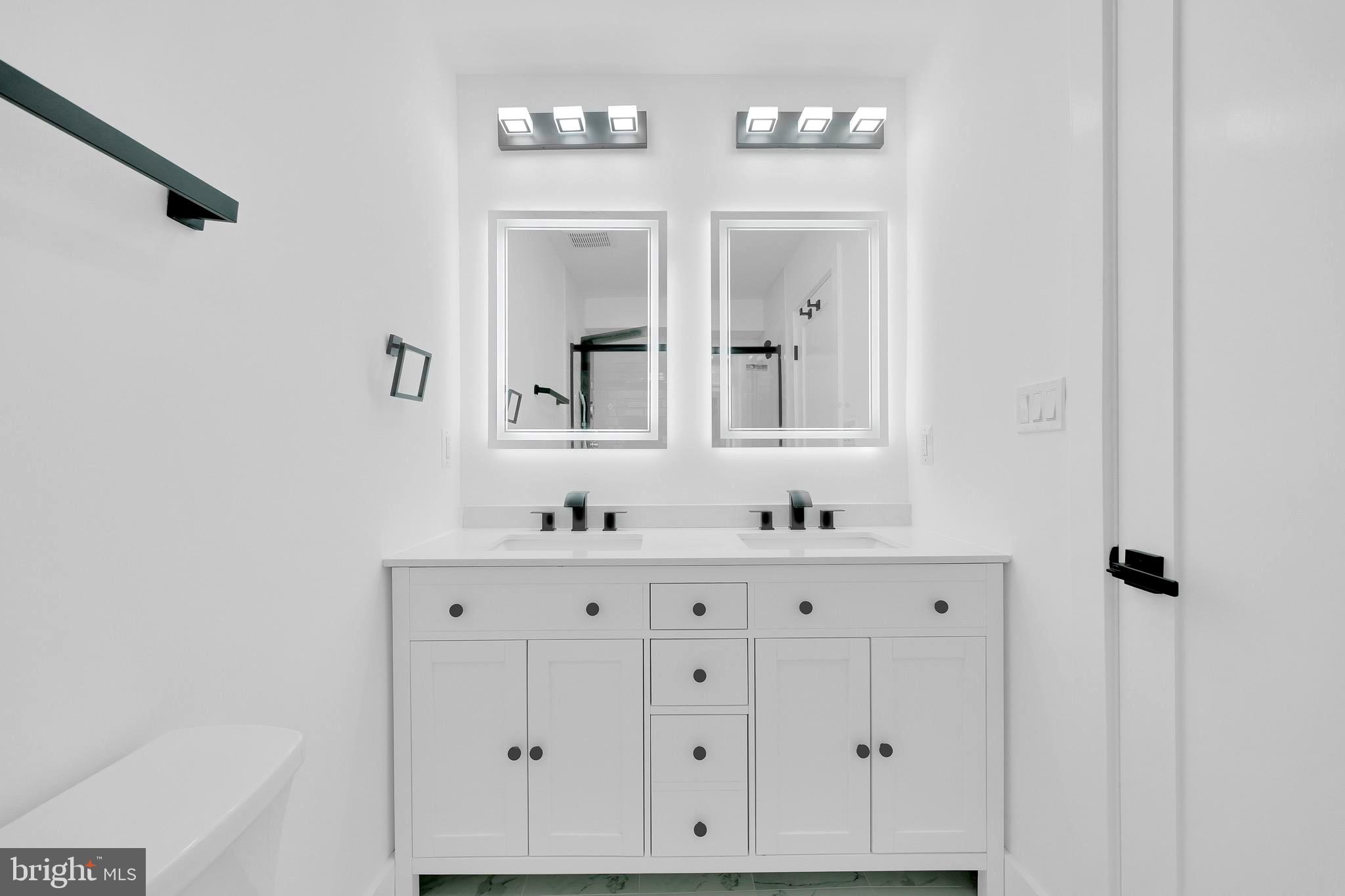 5318 5th Street Northwest Washington, DC 20011 - Photo 21 of 40 a bathroom with a sink vanity and mirror