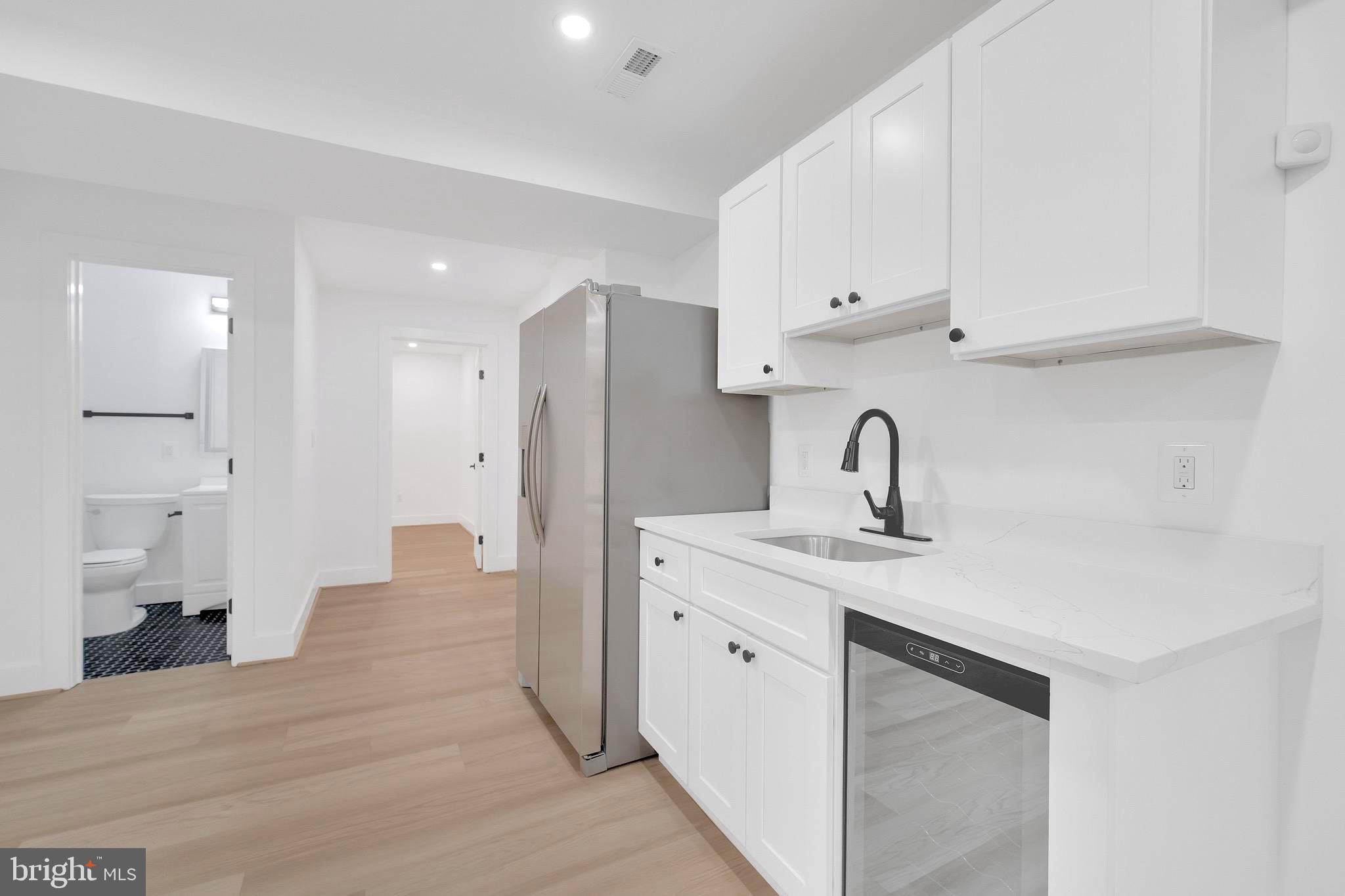 5318 5th Street Northwest Washington, DC 20011 - Photo 31 of 40 a kitchen with stainless steel appliances a sink cabinets and wooden floor
