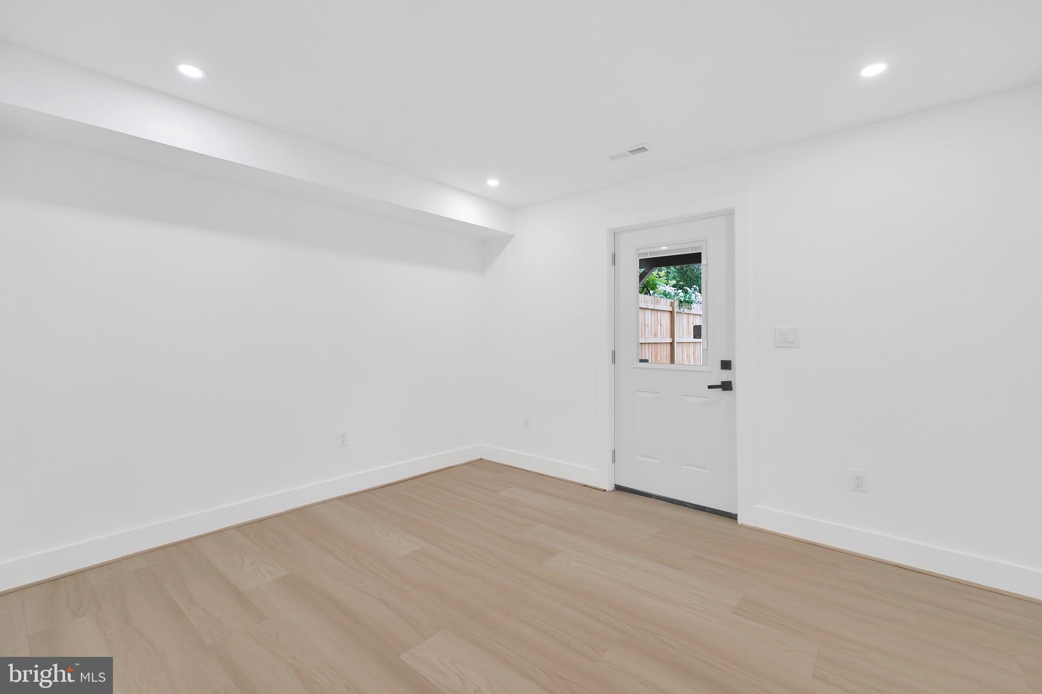 5318 5th Street Northwest Washington, DC 20011 - Photo 32 of 40 an empty room with wooden floor and mirror
