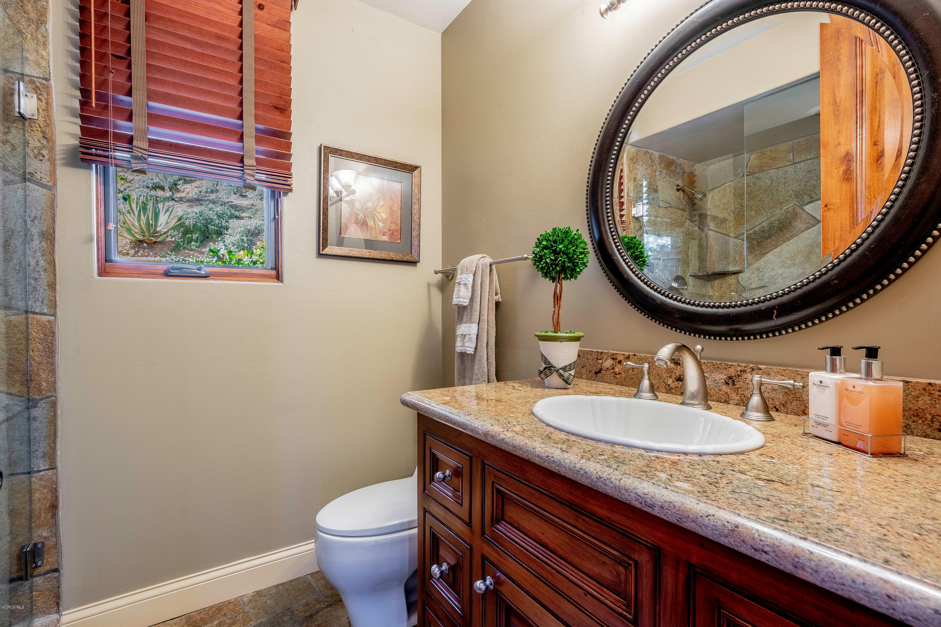 525 Rimrock Road Thousand Oaks, CA 91361 - Photo 27 of 95 a bathroom with a toilet a sink and a mirror