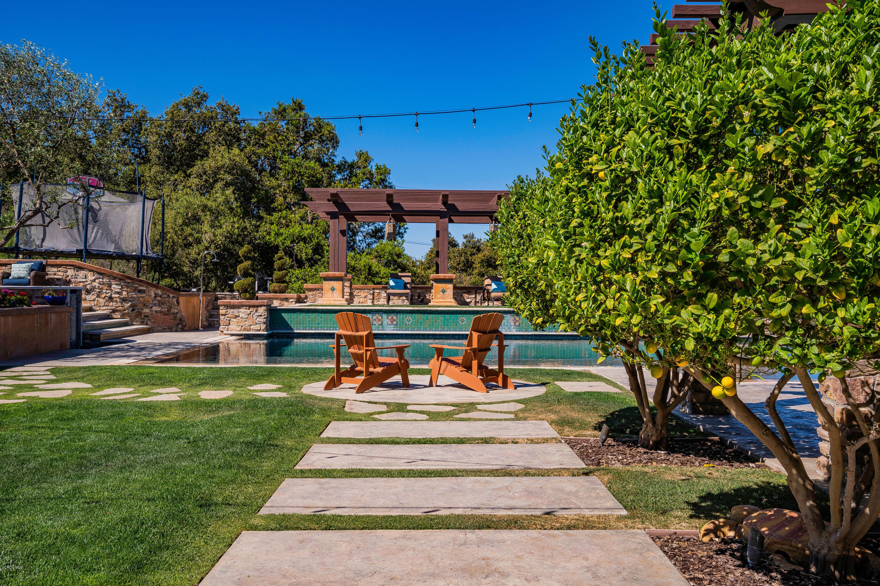 525 Rimrock Road Thousand Oaks, CA 91361 - Photo 46 of 95 a view of a patio with table and chairs potted plants and large tree