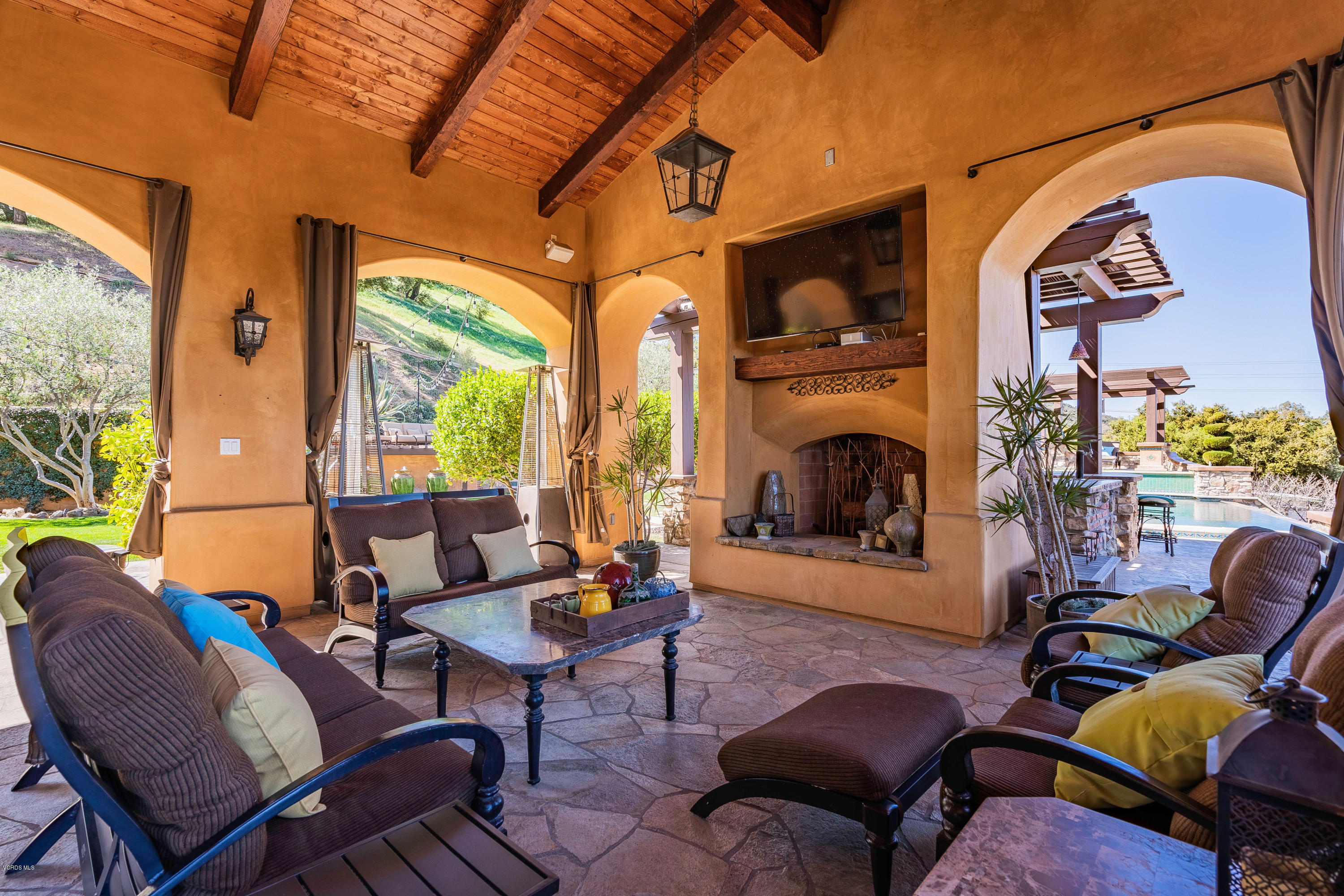 525 Rimrock Road Thousand Oaks, CA 91361 - Photo 59 of 95 a living room with furniture a fireplace and a floor to ceiling window