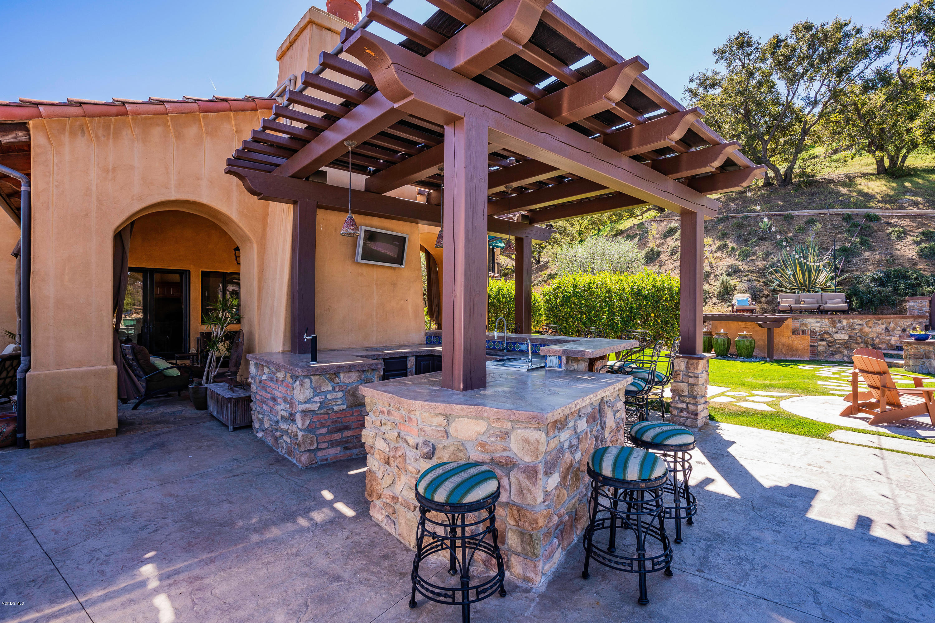 525 Rimrock Road Thousand Oaks, CA 91361 - Photo 61 of 95 a view of a patio with a table chairs and a backyard
