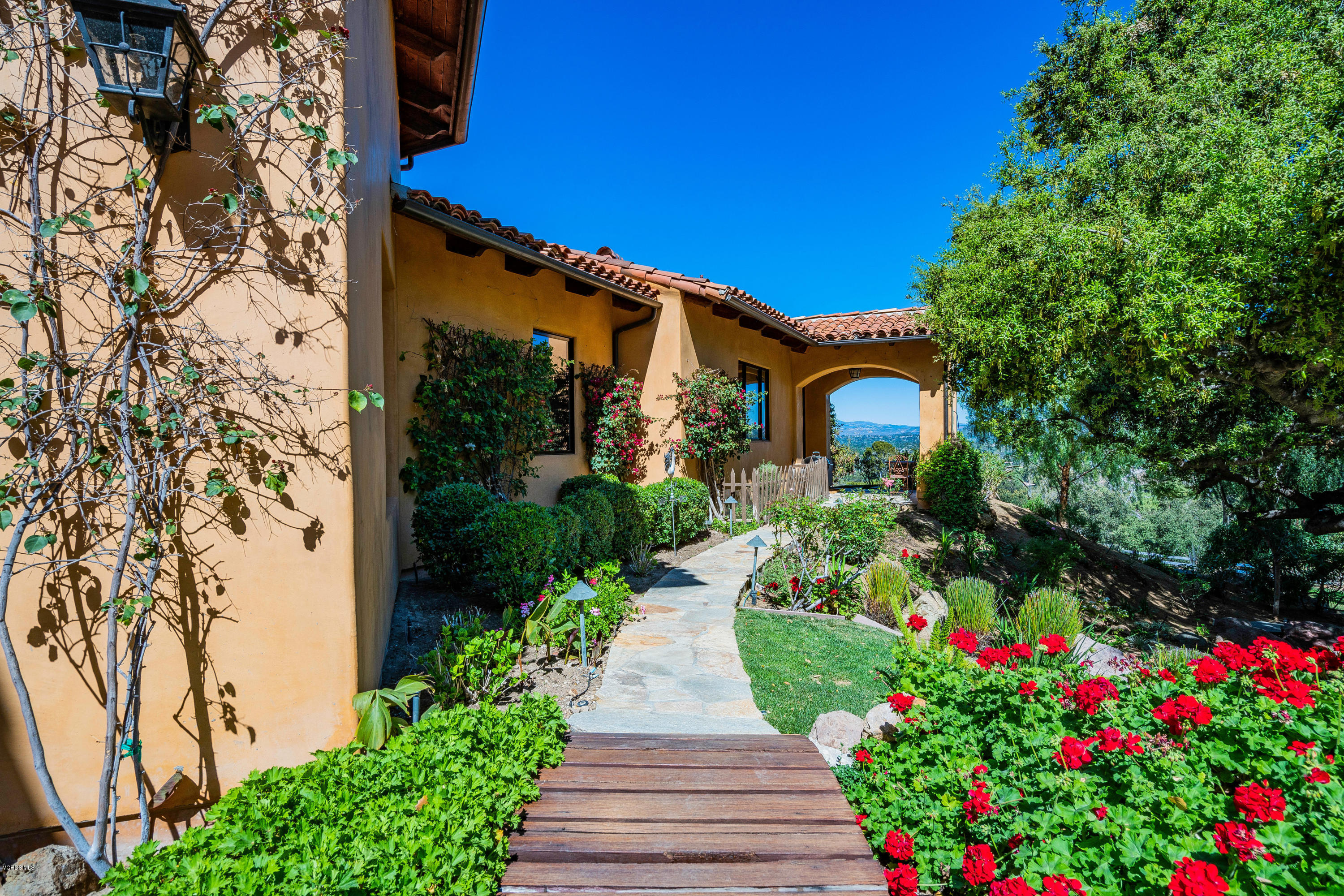 525 Rimrock Road Thousand Oaks, CA 91361 - Photo 83 of 95 a front view of a house with a yard and fountain in middle
