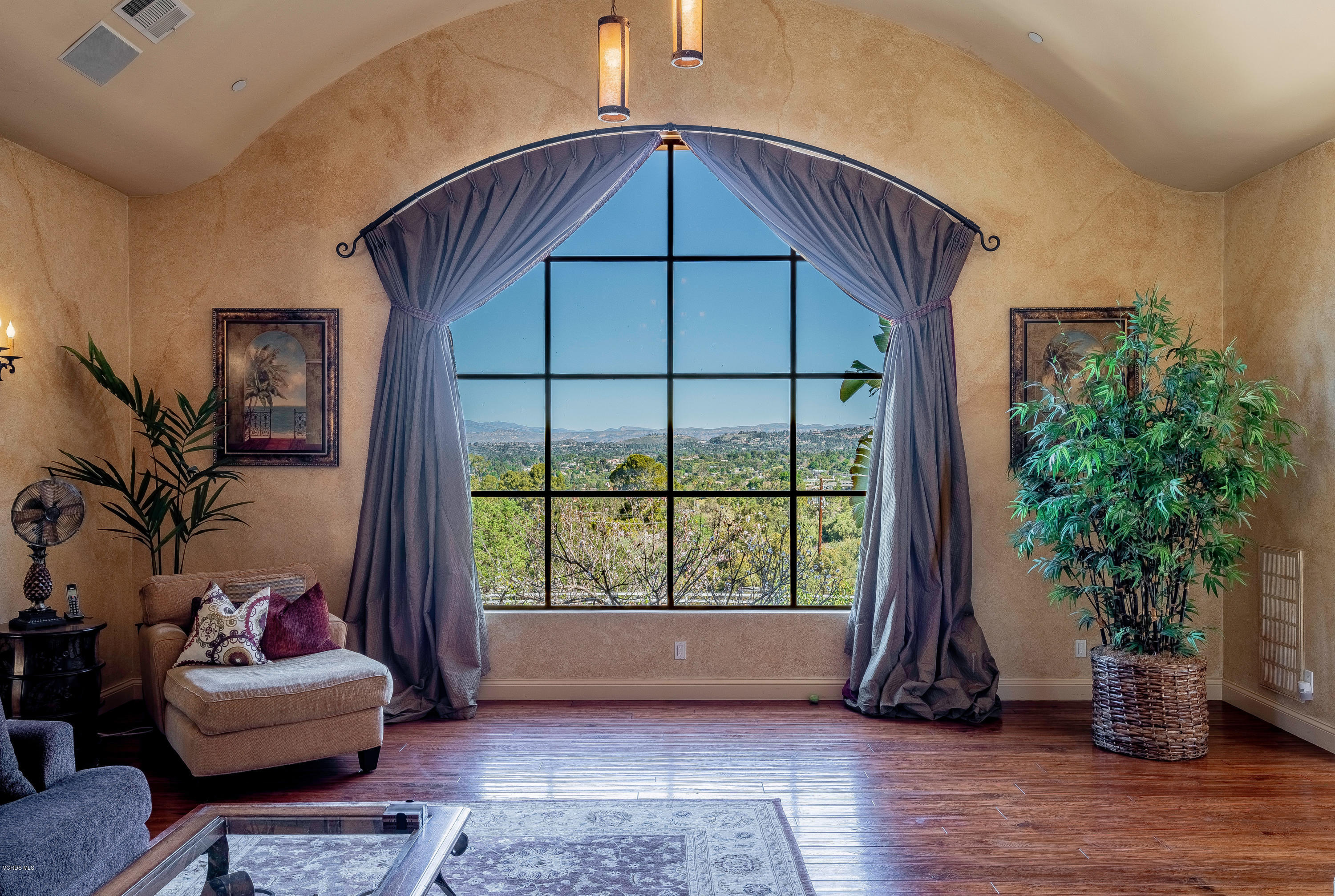 525 Rimrock Road Thousand Oaks, CA 91361 - Photo 10 of 95 a view of an empty room with wooden floor and a potted plant