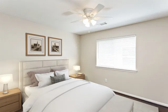 a bedroom with a large bed and a window