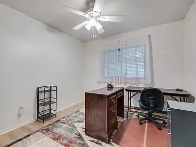 a view of a workspace with furniture and a window