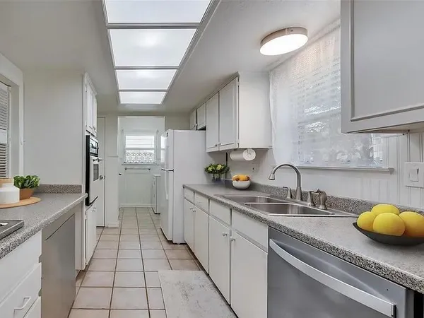 a kitchen with a sink and cabinets