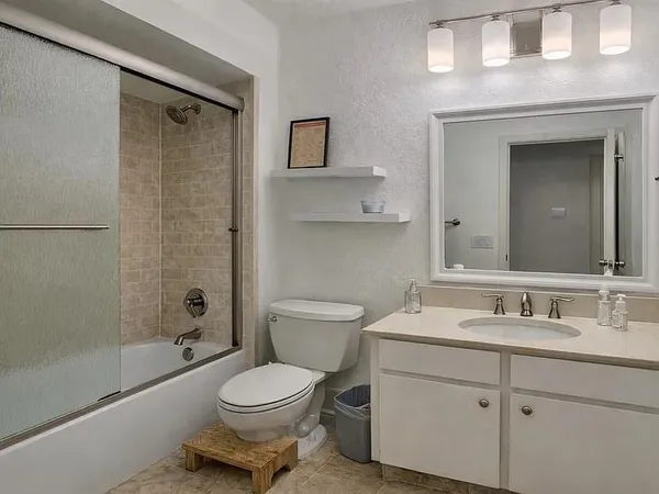 a bathroom with a toilet a sink and mirror