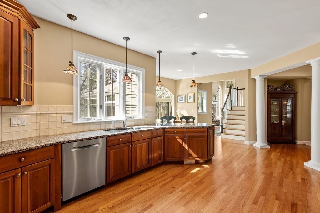 28 Cutler Farm Road Sudbury, MA 01776 - Photo 11 of 42 a open kitchen with stainless steel appliances granite countertop a sink and wooden cabinets