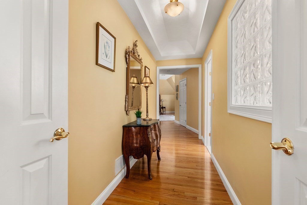 28 Cutler Farm Road Sudbury, MA 01776 - Photo 21 of 42 a view of a hallway with wooden floor and staircase