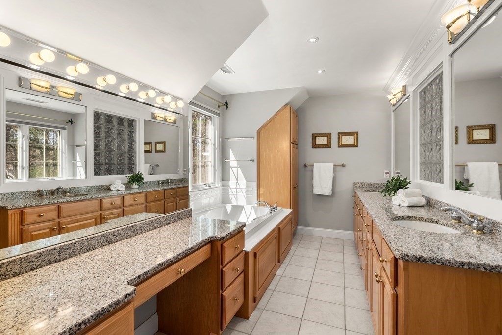 28 Cutler Farm Road Sudbury, MA 01776 - Photo 25 of 42 a bathroom with a granite countertop double vanity sink and a bathtub
