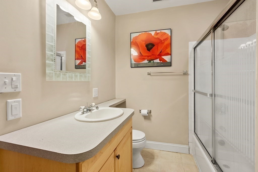 28 Cutler Farm Road Sudbury, MA 01776 - Photo 36 of 42 a bathroom with a sink and a painting on the wall