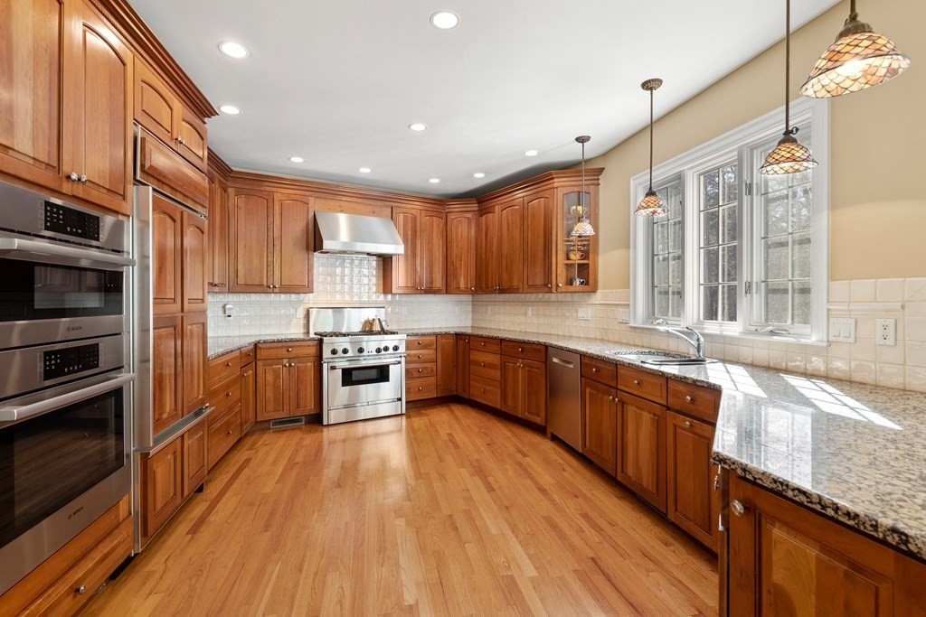 28 Cutler Farm Road Sudbury, MA 01776 - Photo 10 of 42 a large kitchen with stainless steel appliances granite countertop a stove a sink and a refrigerator