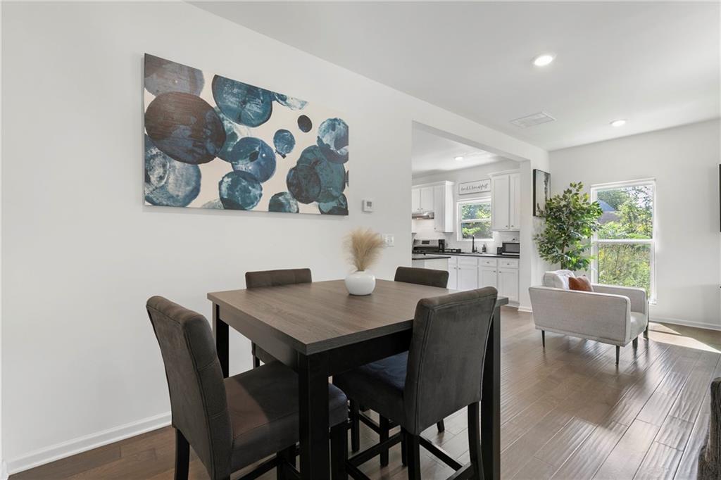 973 Mayson Turner Road Northwest Atlanta, GA 30314 - Photo 11 of 38 a view of a dining room with furniture window and wooden floor