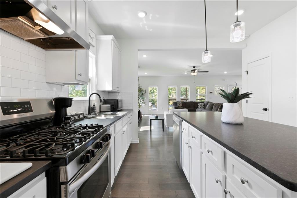 973 Mayson Turner Road Northwest Atlanta, GA 30314 - Photo 14 of 38 a kitchen with sink stove and cabinets